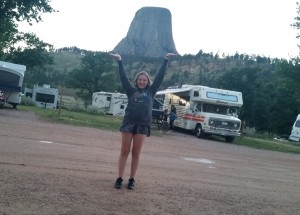 Grace, pretending to hold up Devils Tower at our campground.